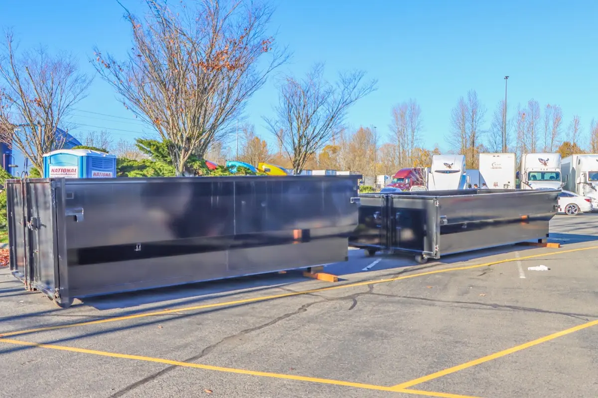 Professional dumpster rental service with roll-off container on residential driveway in Fort Meade